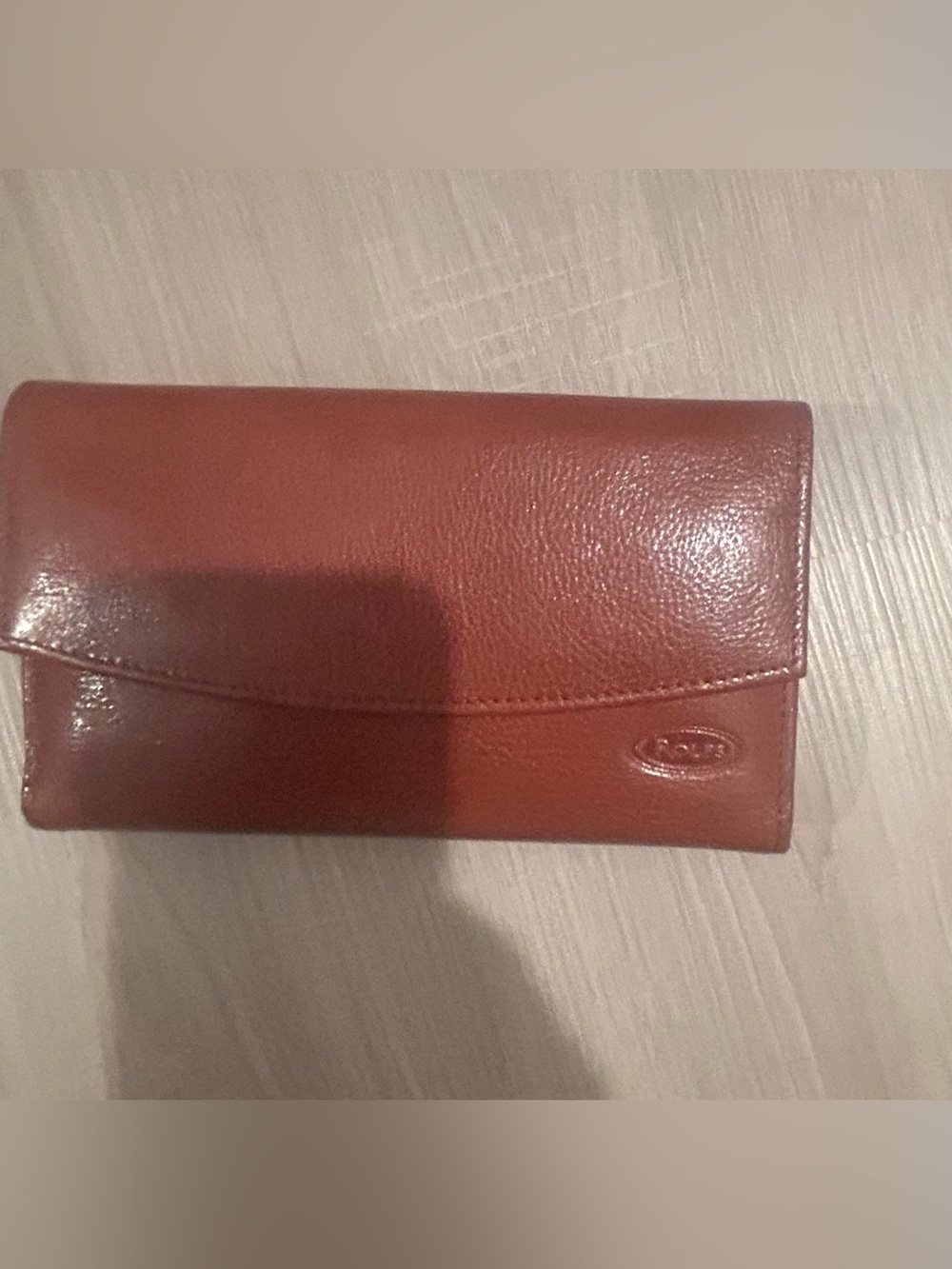 Rolfs brown leather card case with gold detail